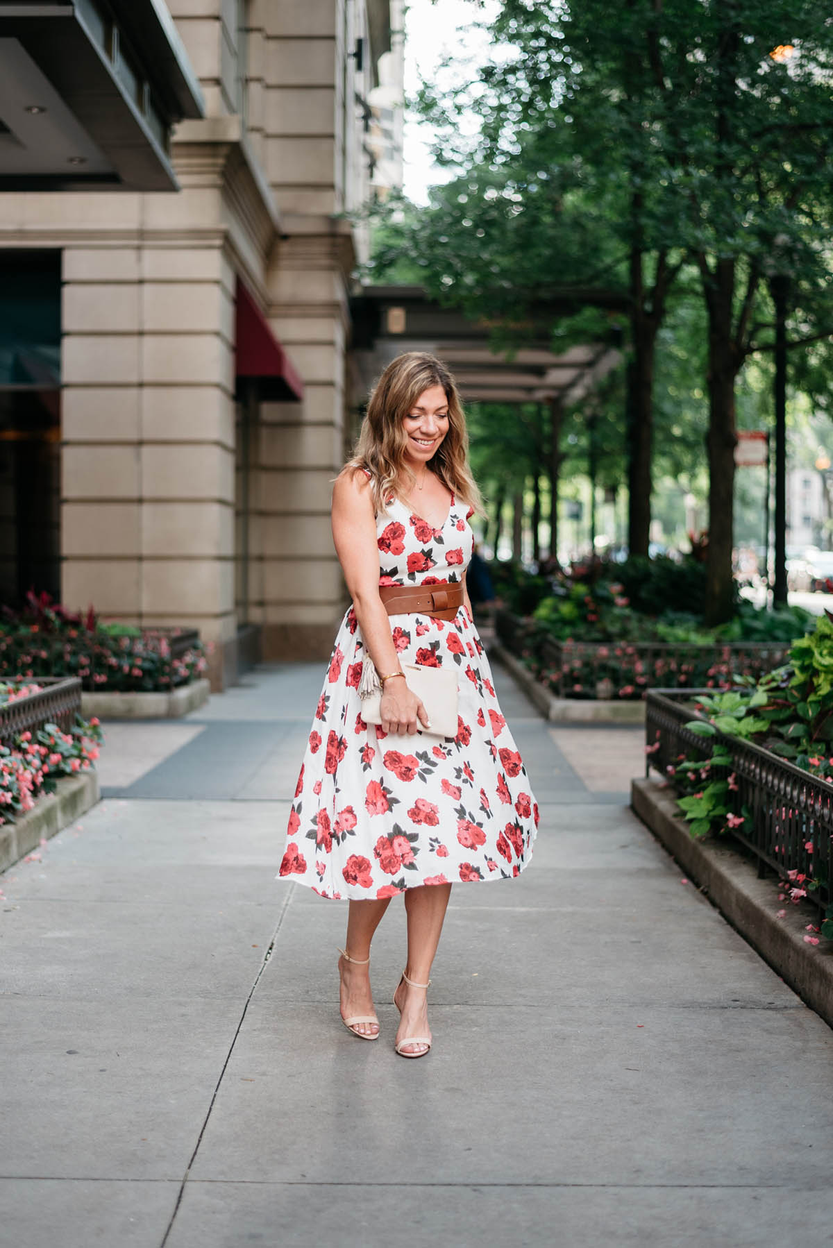 chicago blogger corals and cognacs wearing floral dress for a wedding with nude high heel sandals