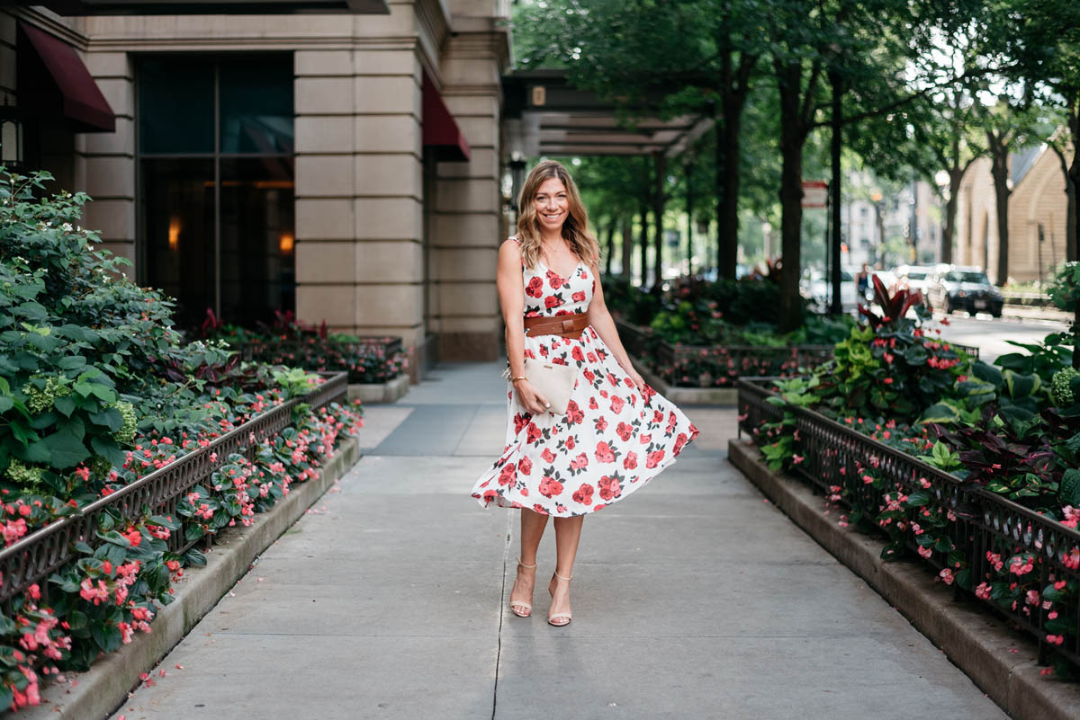 blogger wearing a petite floral dress and nude sandals